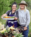 Rebekkah from Rebekkah's Kitchen showing off her sustainably prepared meal in an outdoor setting with a friend.